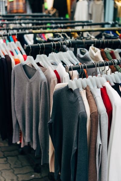 Garments hanging on rails in a clothing shop